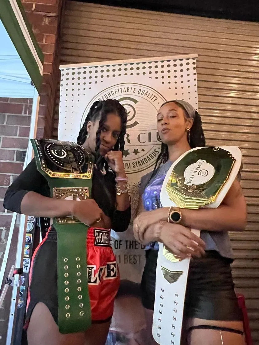 Caviar Club members holding the club's championship belts