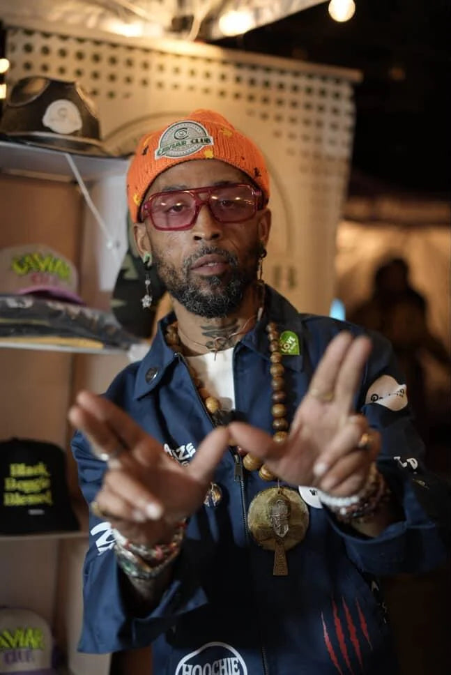 Worthy wearing an orange Caviar Club beanie
